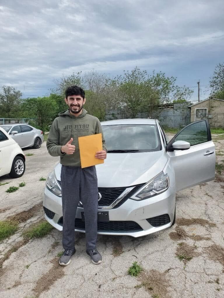 A happy Cedar Auto Sale customer with their newly purchased car
